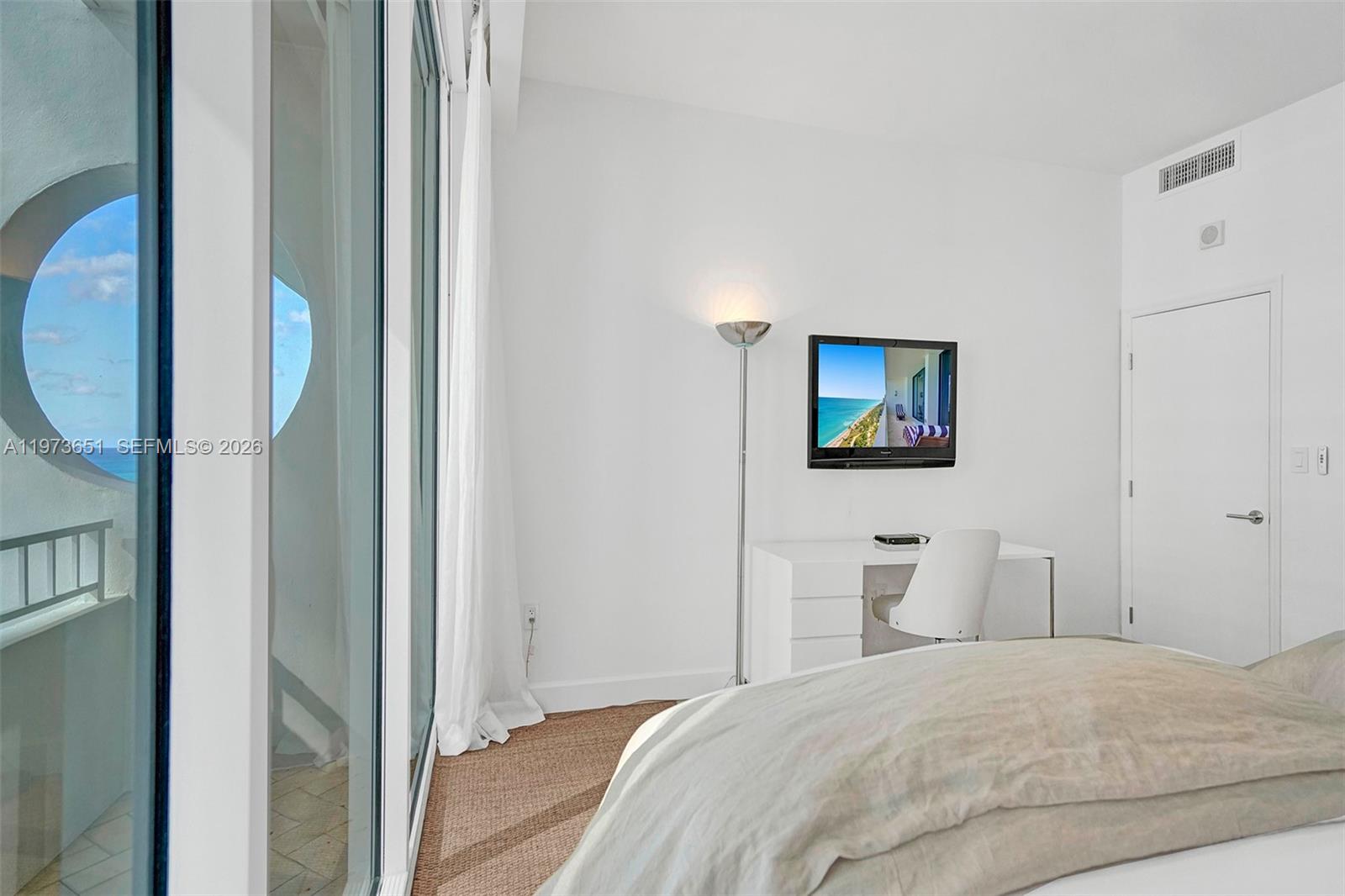 10205 Collins Avenue, Unit P8 Bal Harbour, FL 33154 - Photo 47 of 56 a bedroom with a bed and a flat screen tv