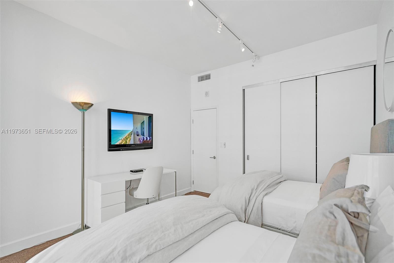 10205 Collins Avenue, Unit P8 Bal Harbour, FL 33154 - Photo 48 of 56 a bedroom with a bed and a flat screen tv