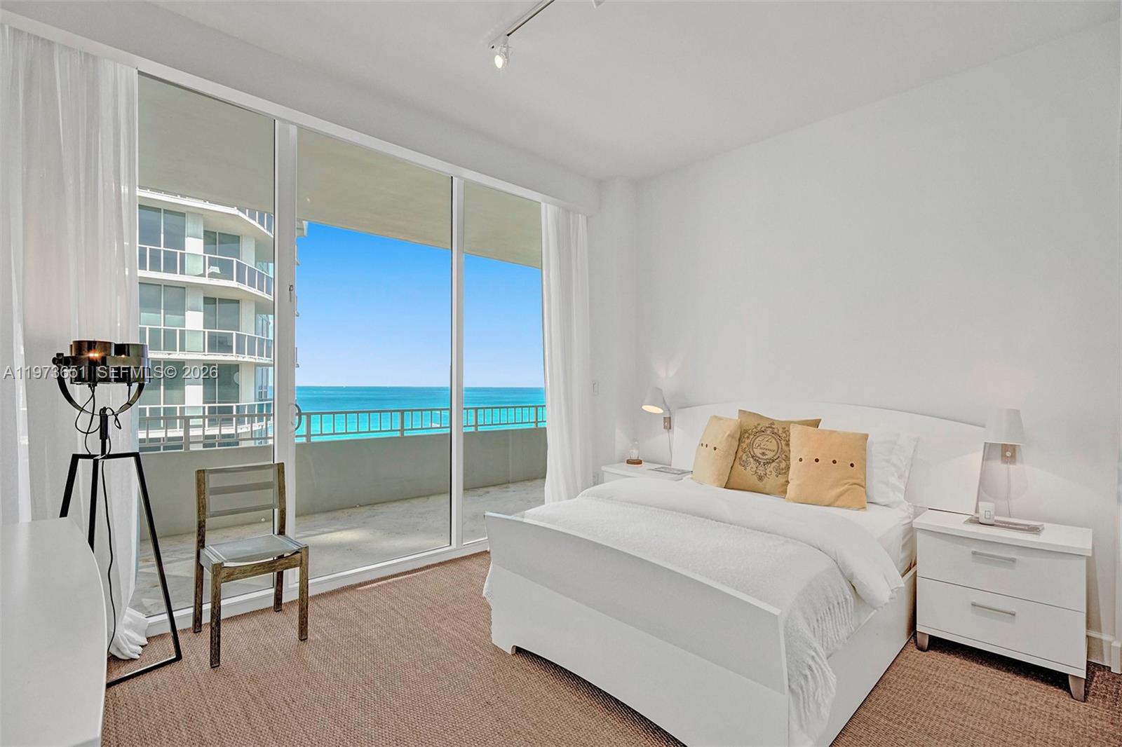 10205 Collins Avenue, Unit P8 Bal Harbour, FL 33154 - Photo 50 of 56 a bedroom with a bed and a cabinets