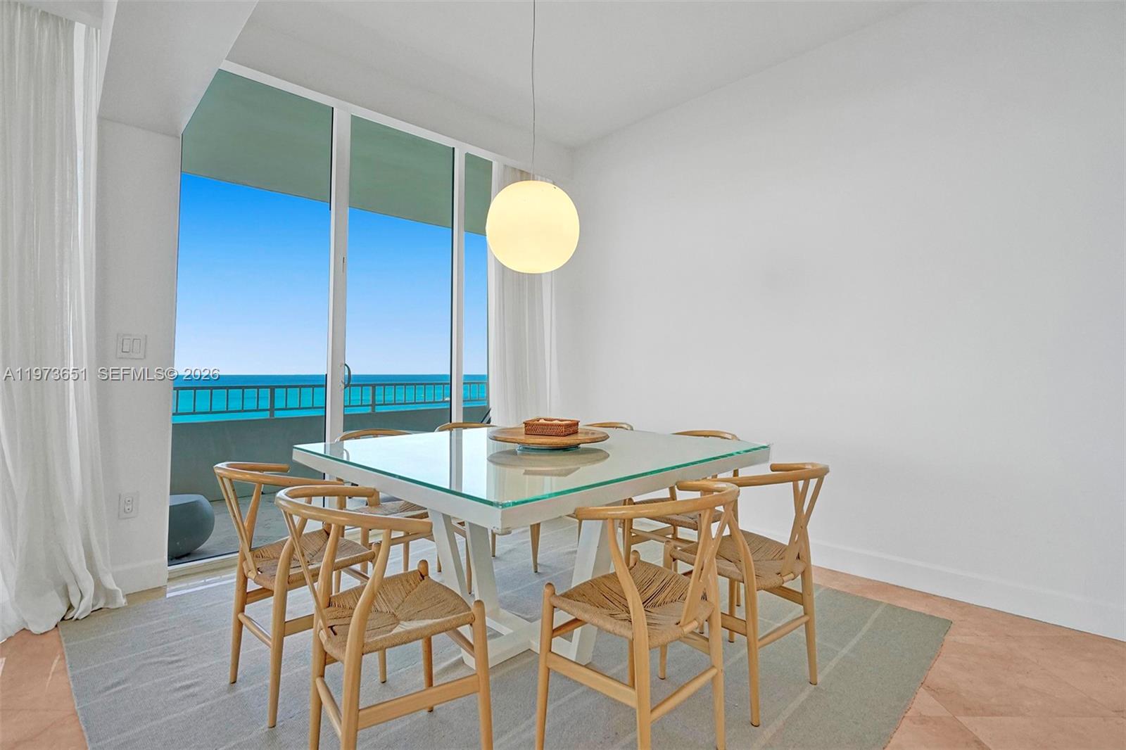 10205 Collins Avenue, Unit P8 Bal Harbour, FL 33154 - Photo 6 of 56 a view of a table and chairs in wooden floor