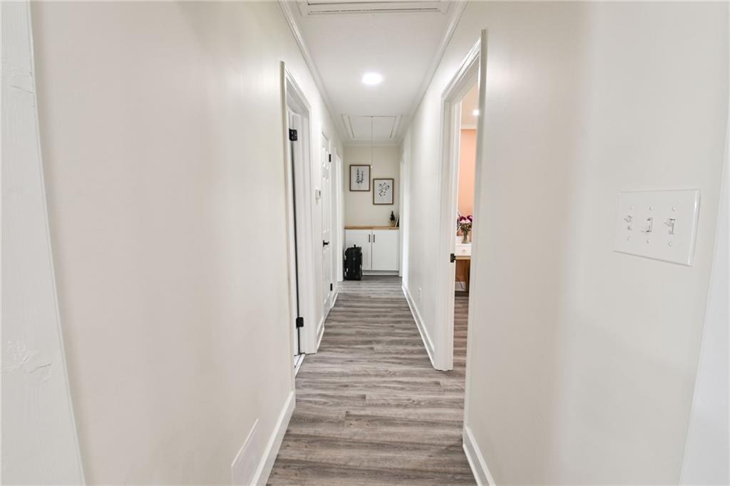 150 Sims Street Winder, GA 30680 - Photo 30 of 61 a view of a hallway with wooden floor and staircase