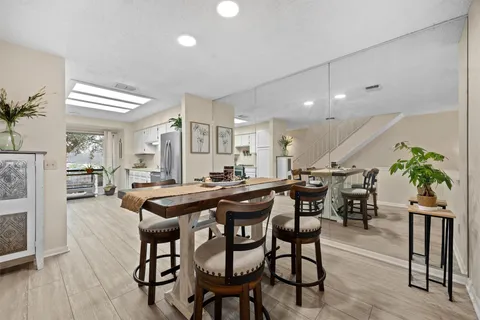 a dining room with furniture and wooden floor