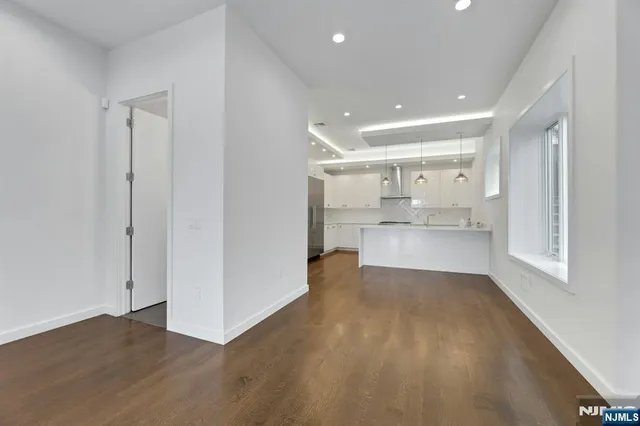 a view of a kitchen with wooden floor