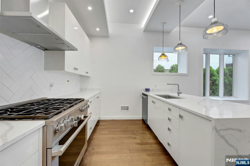 714 Undercliff Avenue, Unit 714 Edgewater, NJ 07020 - Photo 17 of 45 a kitchen with granite countertop a stove and a sink