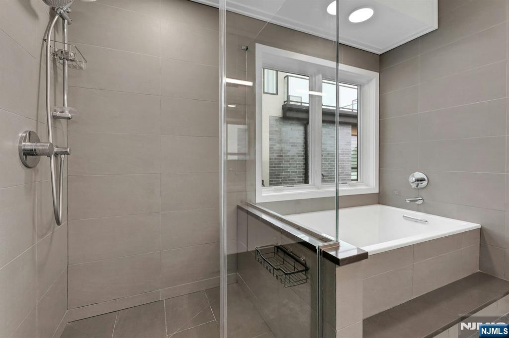 714 Undercliff Avenue, Unit 714 Edgewater, NJ 07020 - Photo 27 of 45 a bathroom with a tub and shower