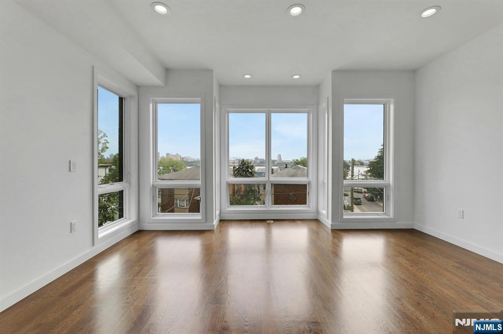 714 Undercliff Avenue, Unit 714 Edgewater, NJ 07020 - Photo 28 of 45 a view of an empty room with wooden floor and a window