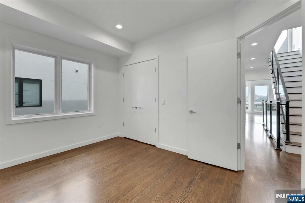714 Undercliff Avenue, Unit 714 Edgewater, NJ 07020 - Photo 31 of 45 a view of empty room with wooden floor and fan