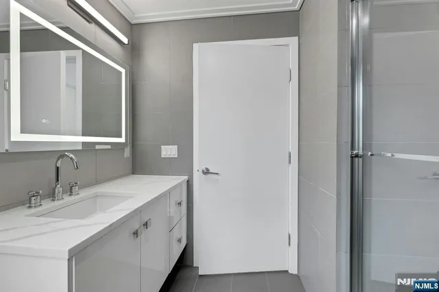 a bathroom with a double vanity sink and mirror