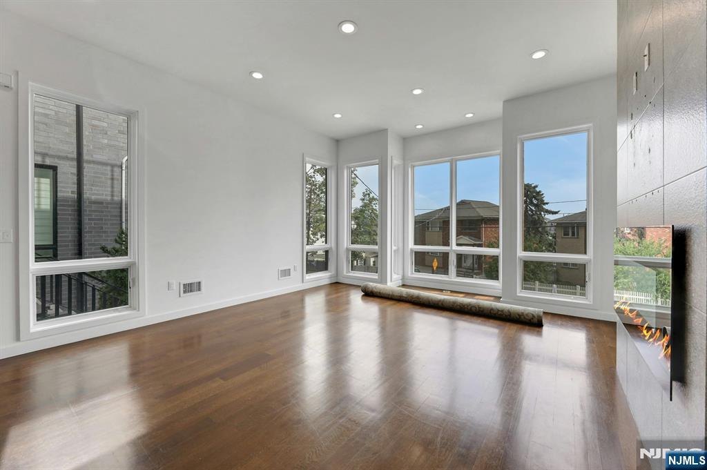 714 Undercliff Avenue, Unit 714 Edgewater, NJ 07020 - Photo 5 of 45 a view of room with window and wooden floor