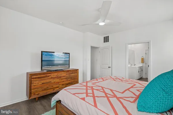 a bedroom with a bed and a couch