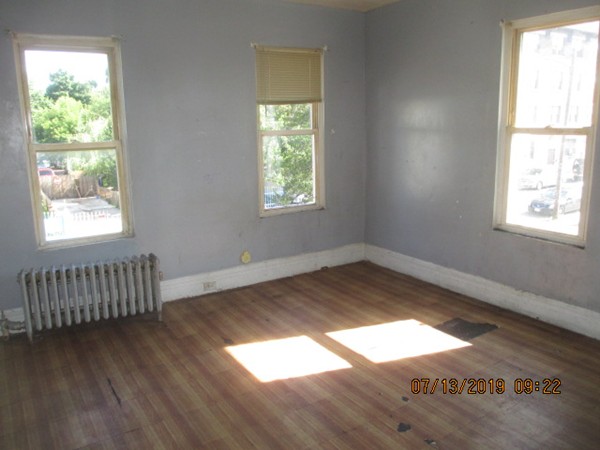 85 Ashley Street Springfield, MA 01105 - Photo 12 of 13 a view of empty room with wooden floor and fan