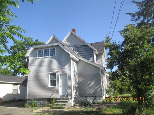 85 Ashley Street Springfield, MA 01105 - Photo 4 of 13 a front view of a house with a yard