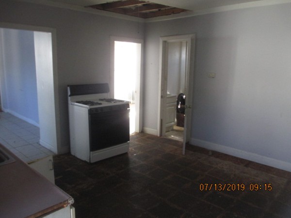 85 Ashley Street Springfield, MA 01105 - Photo 7 of 13 a view of a kitchen in an empty room