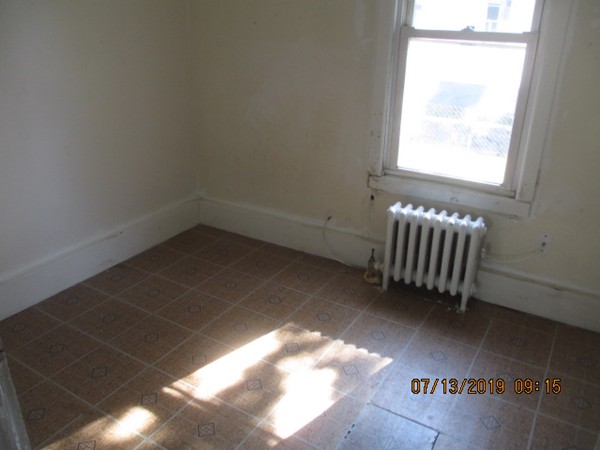 85 Ashley Street Springfield, MA 01105 - Photo 8 of 13 a view of wooden floor and windows in a room