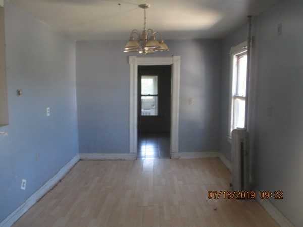 85 Ashley Street Springfield, MA 01105 - Photo 10 of 13 wooden floor in an empty room with a window