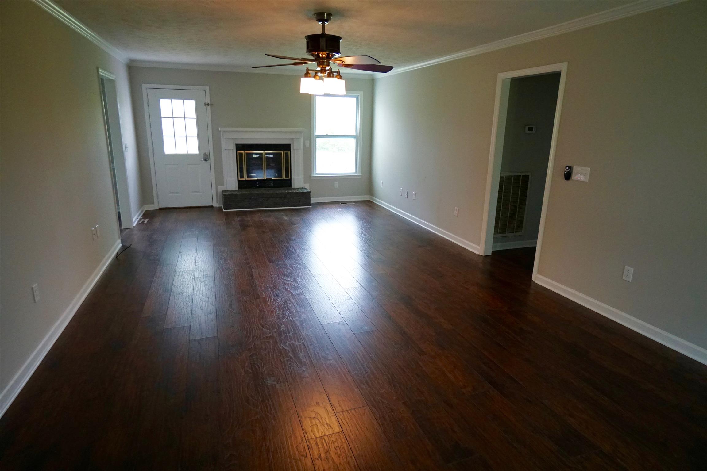 7390 Almaville Road Arrington, TN 37014 - Photo 2 of 15 Living room with new laminate flooring and gas fireplace
