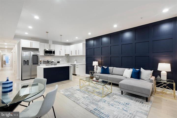 525 Kennedy Street Northwest, Unit 1 Washington, DC 20011 - Photo 1 of 27 a living room with stainless steel appliances kitchen island granite countertop a couch and cabinets