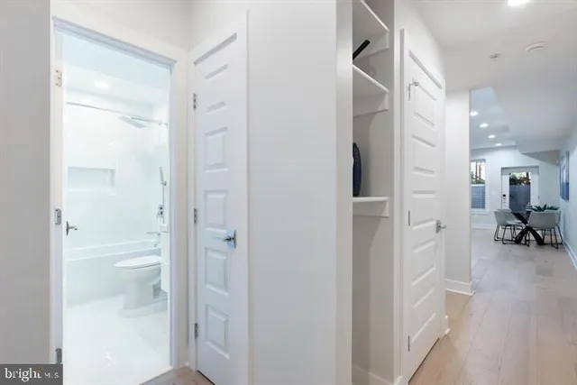 a bathroom with a glass shower door and a toilet