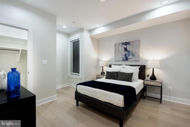 525 Kennedy Street Northwest, Unit 1 Washington, DC 20011 - Photo 17 of 27 a bedroom with a bed and wooden floor