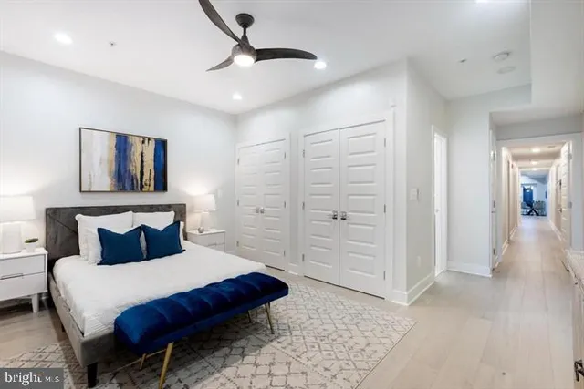 a bedroom with a bed and closet with mirror