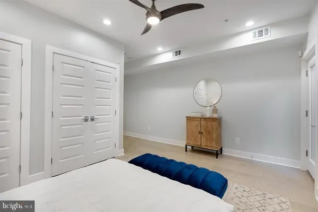 a bedroom with a bed and cabinets