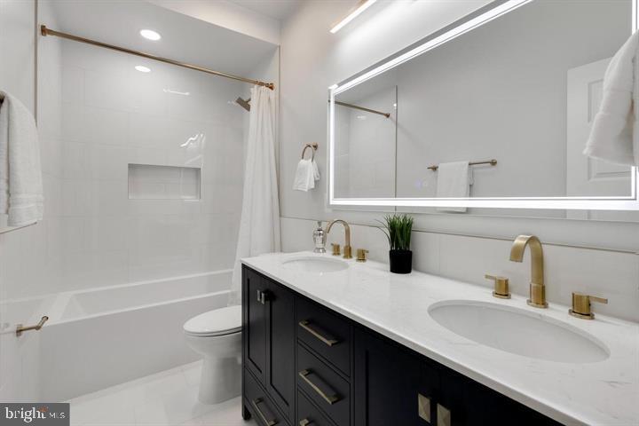 525 Kennedy Street Northwest, Unit 1 Washington, DC 20011 - Photo 23 of 27 a bathroom with a sink double vanity granite tub shower and a mirror