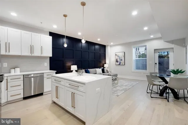 a kitchen with a stove a sink a dining table and chairs