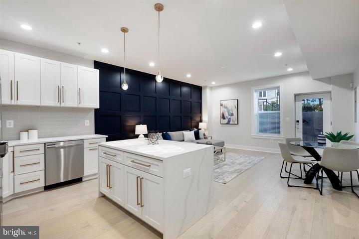 525 Kennedy Street Northwest, Unit 1 Washington, DC 20011 - Photo 5 of 27 a kitchen with a stove a sink a dining table and chairs