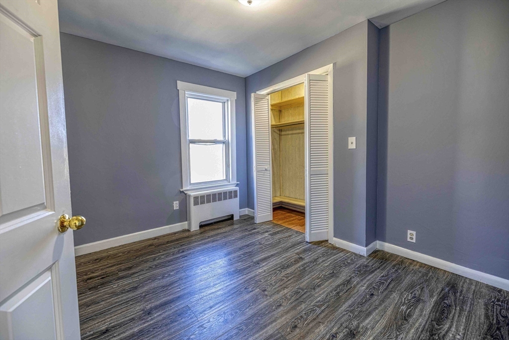 15 Higgins Street Fall River, MA 02724 - Photo 11 of 16 an empty room with wooden floor and windows
