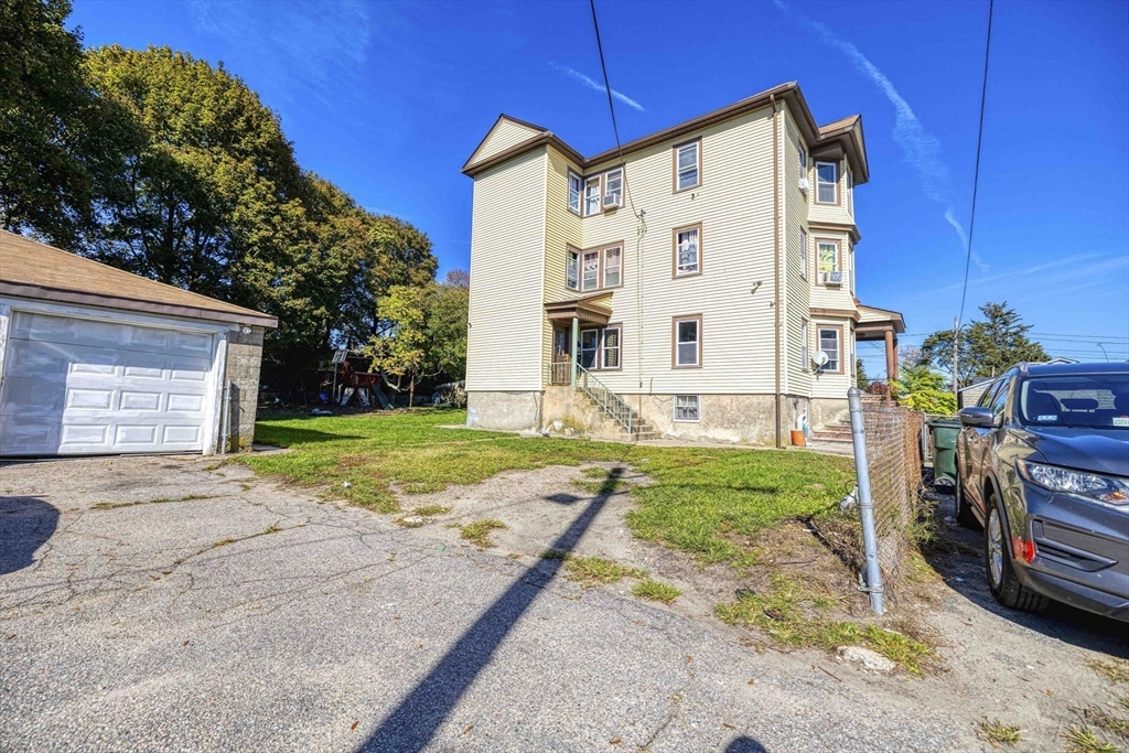 15 Higgins Street Fall River, MA 02724 - Photo 12 of 16 a view of a house with backyard and garden