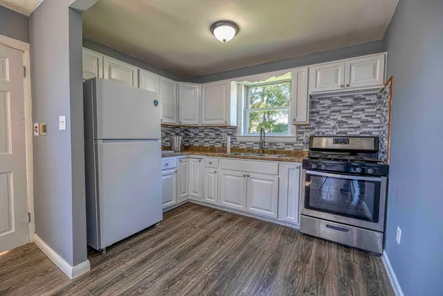 a kitchen with a refrigerator stove and sink