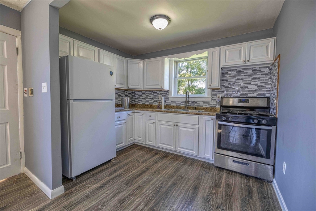 15 Higgins Street Fall River, MA 02724 - Photo 5 of 16 a kitchen with a refrigerator stove and sink