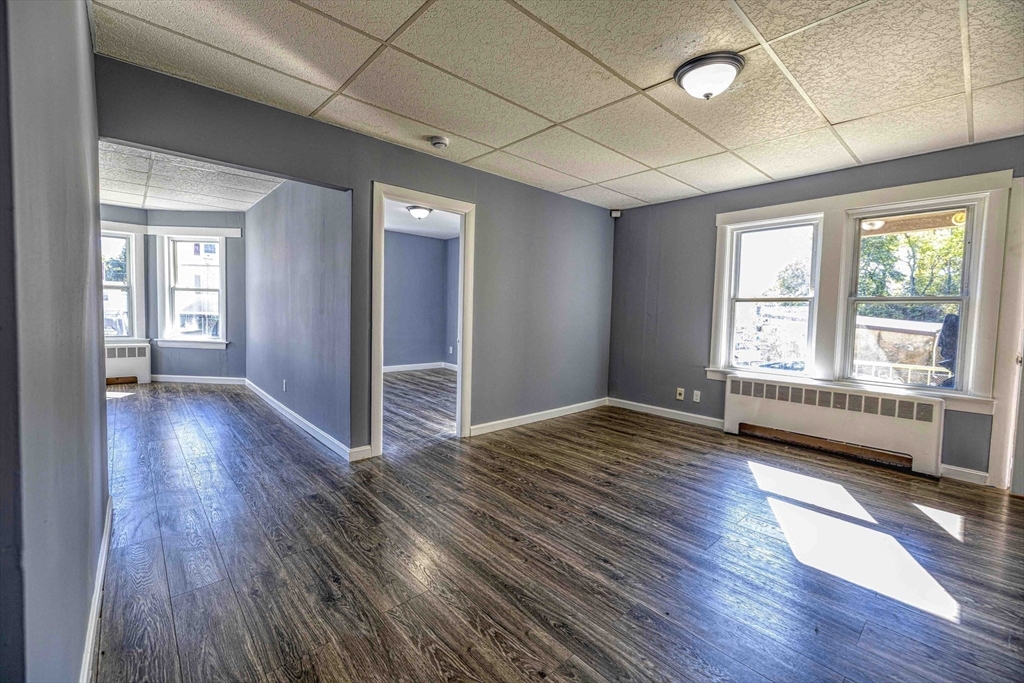 15 Higgins Street Fall River, MA 02724 - Photo 6 of 16 a view of empty room with wooden floor and fan