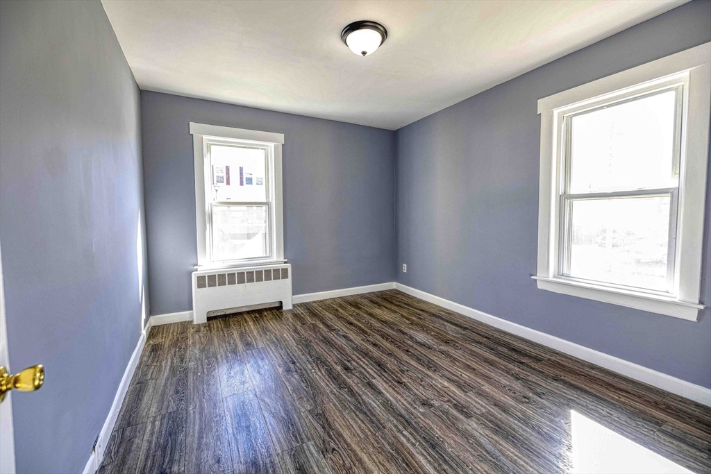 15 Higgins Street Fall River, MA 02724 - Photo 7 of 16 a view of a room with wooden floor and windows