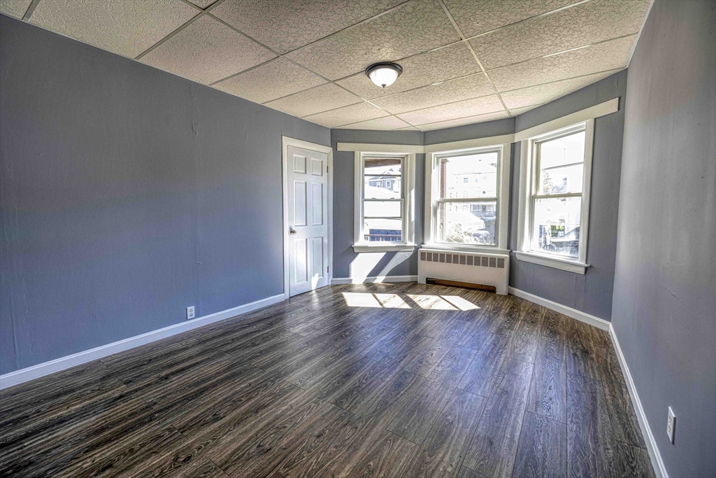 15 Higgins Street Fall River, MA 02724 - Photo 8 of 16 a view of an empty room with wooden floor and a window