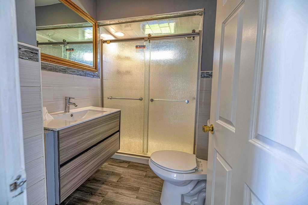 15 Higgins Street Fall River, MA 02724 - Photo 9 of 16 a bathroom with a sink a toilet and shower