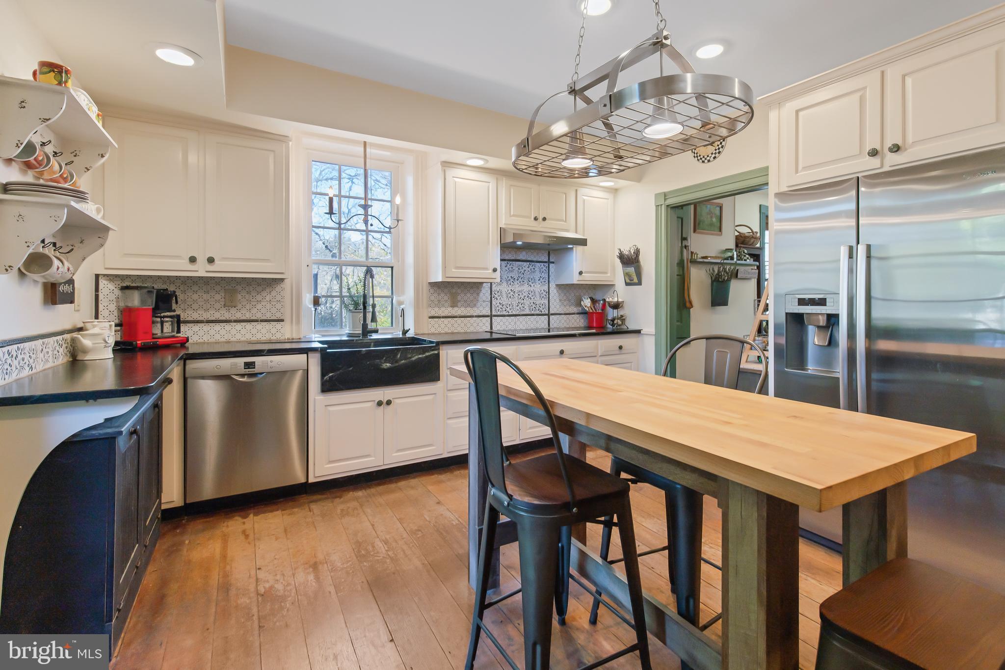 504 2nd Lock Road Lancaster, PA 17603 - Photo 13 of 52 a kitchen with stainless steel appliances granite countertop a table chairs stove and refrigerator