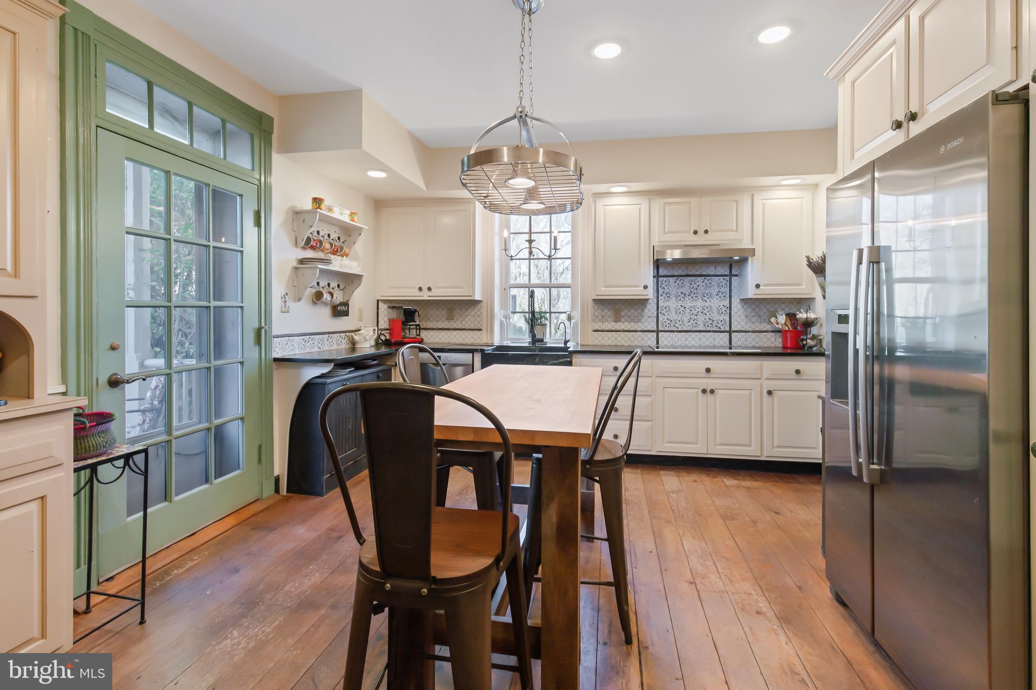 504 2nd Lock Road Lancaster, PA 17603 - Photo 14 of 52 a room with stainless steel appliances kitchen island granite countertop a dining table chairs and a refrigerator