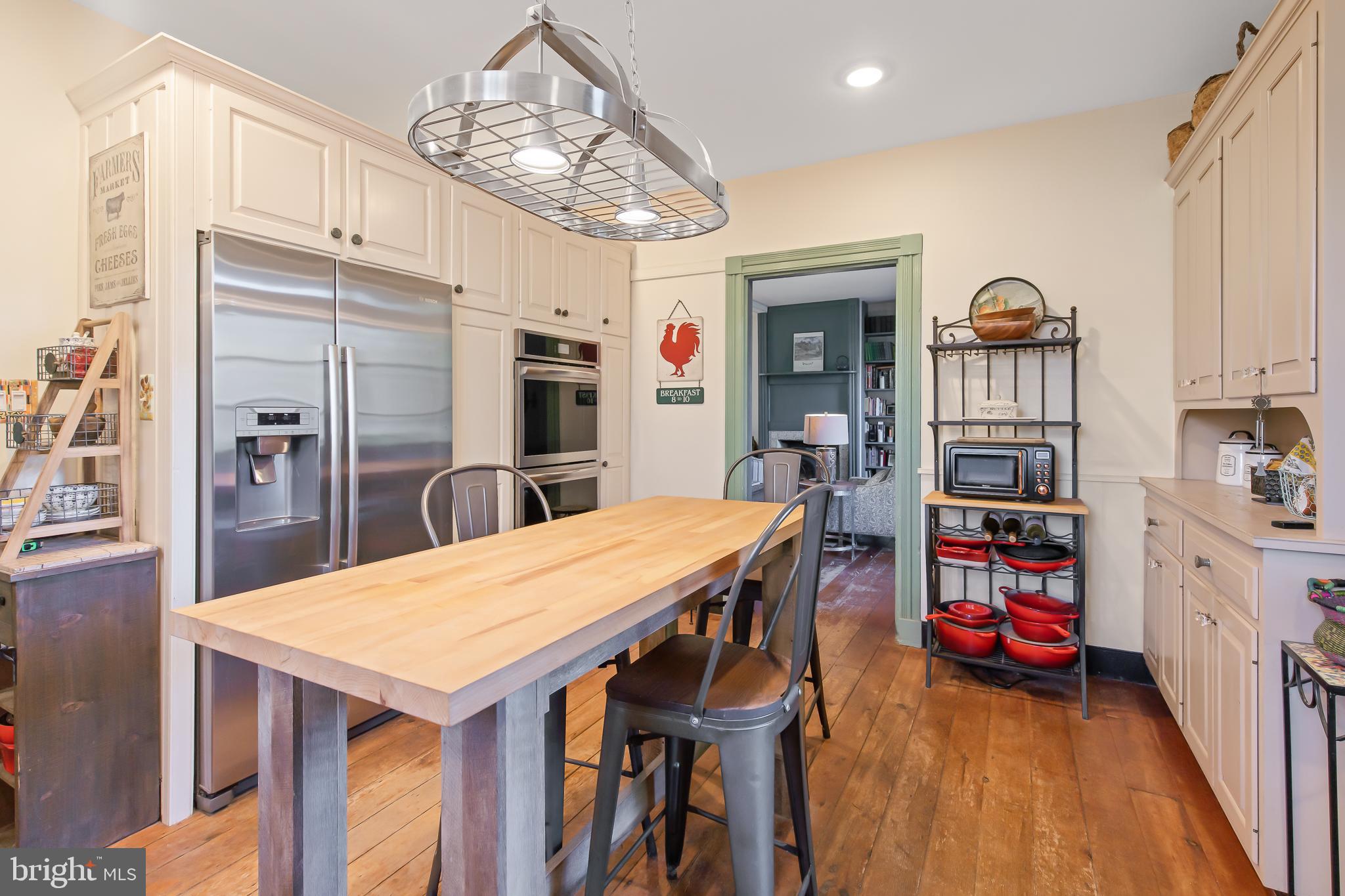 504 2nd Lock Road Lancaster, PA 17603 - Photo 16 of 52 a kitchen with stainless steel appliances a dining table chairs stove and refrigerator