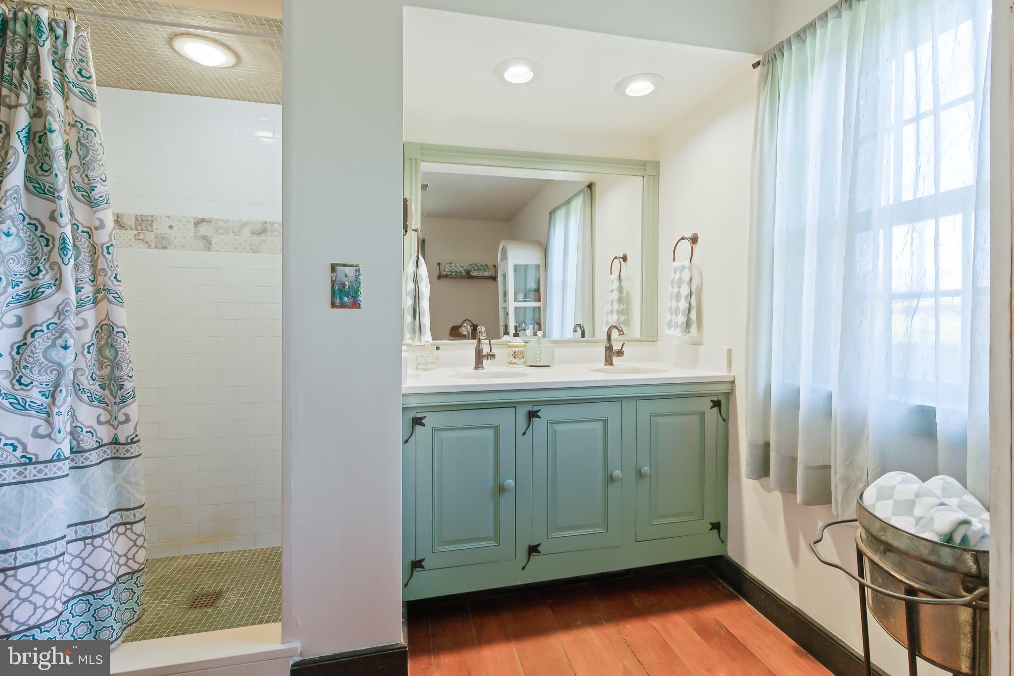 504 2nd Lock Road Lancaster, PA 17603 - Photo 29 of 52 a bathroom with a double vanity sink a mirror and a shower