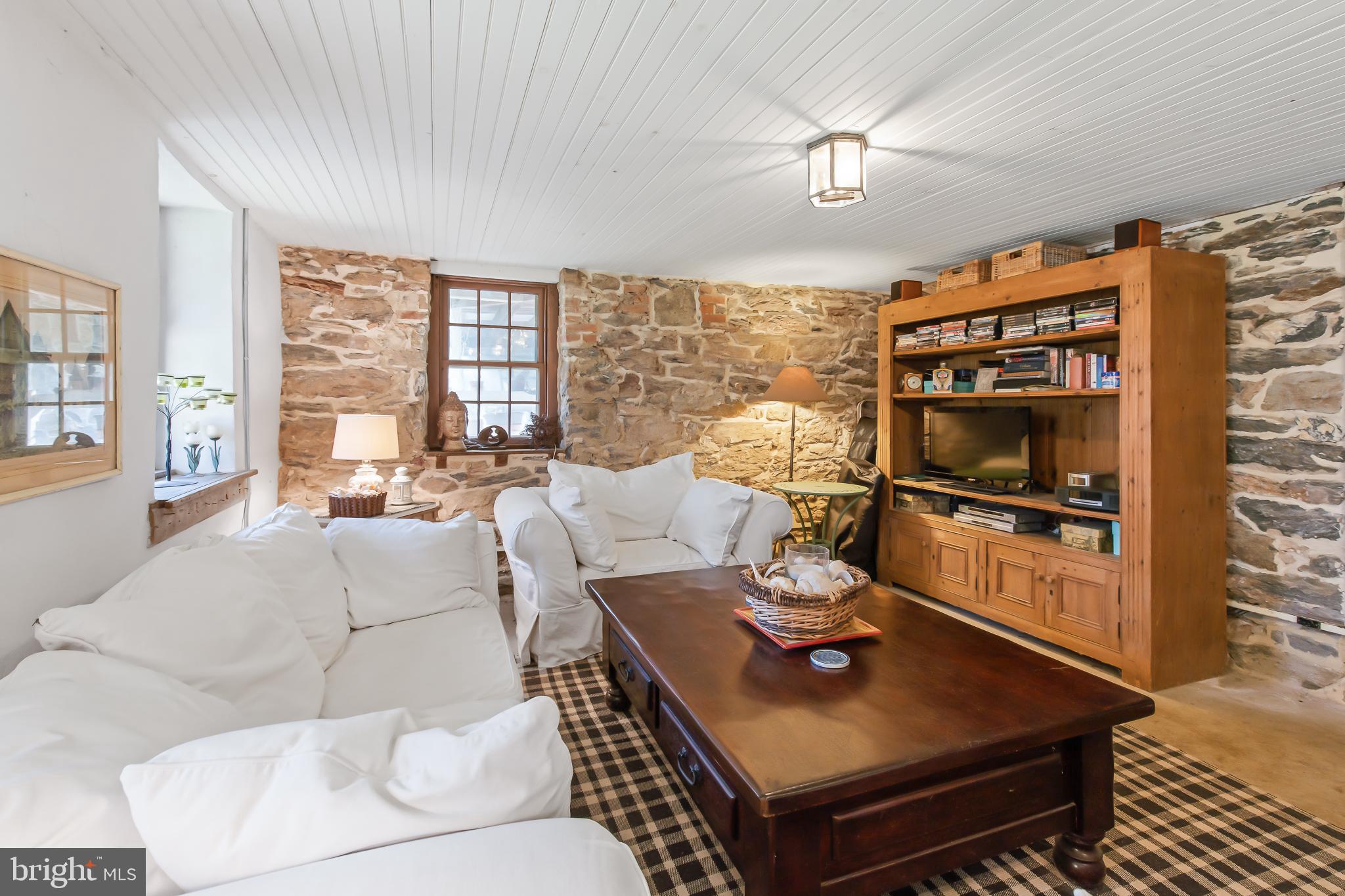 504 2nd Lock Road Lancaster, PA 17603 - Photo 32 of 52 a living room with furniture a flat screen tv and a floor to ceiling window