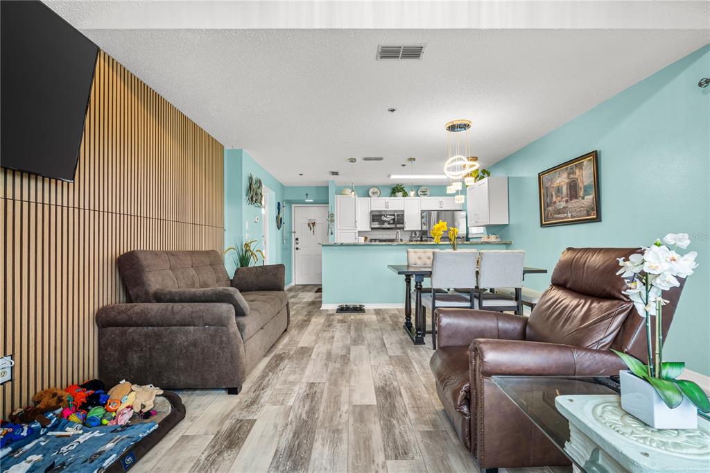 5722 Biscayne Court, Unit 308 New Port Richey, FL 34652 - Photo 13 of 31 a living room with furniture and wooden floor