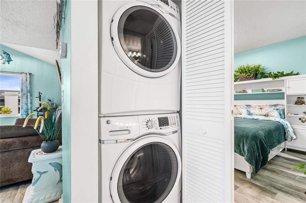 5722 Biscayne Court, Unit 308 New Port Richey, FL 34652 - Photo 17 of 31 a view of a bedroom with washer and dryer