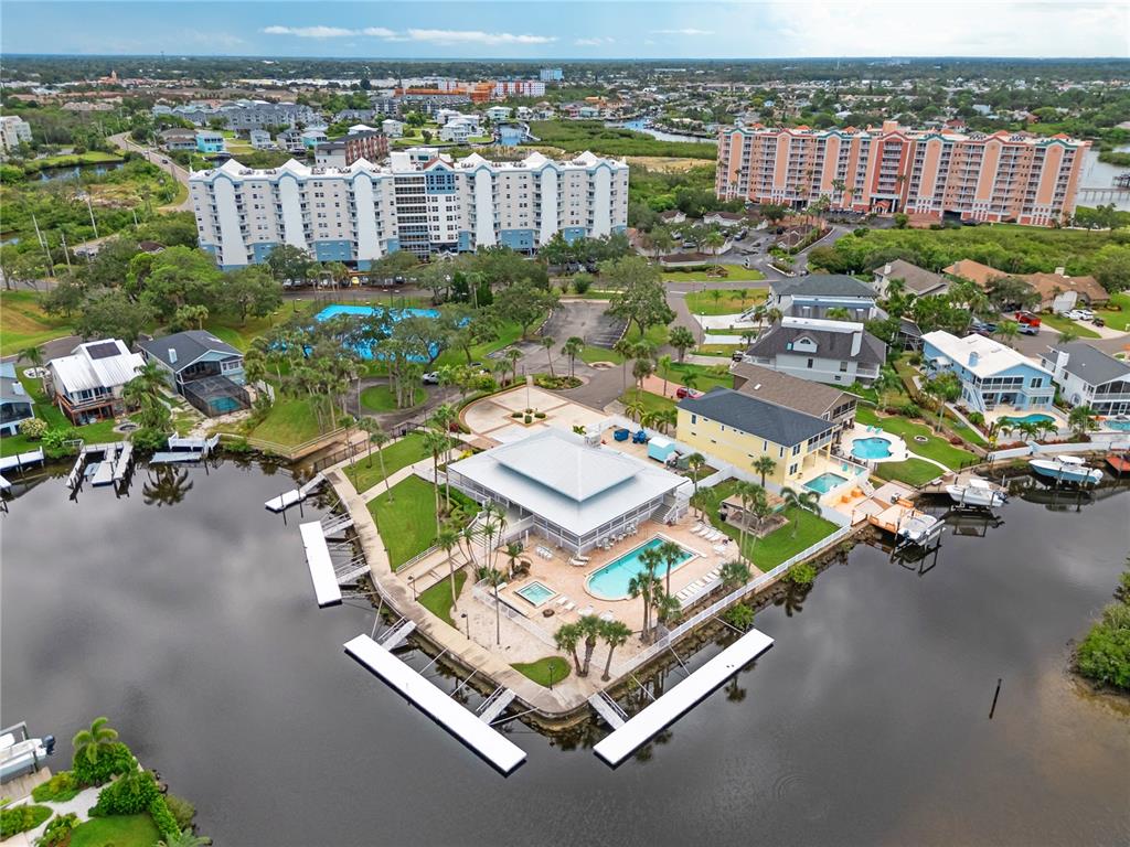 5722 Biscayne Court, Unit 308 New Port Richey, FL 34652 - Photo 28 of 31 an aerial view of a house with a garden and lake view