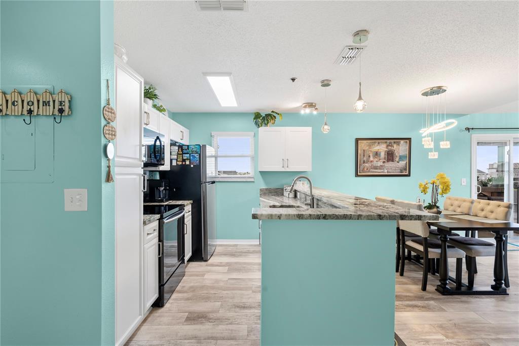 5722 Biscayne Court, Unit 308 New Port Richey, FL 34652 - Photo 5 of 31 a kitchen with stainless steel appliances granite countertop a refrigerator and a sink