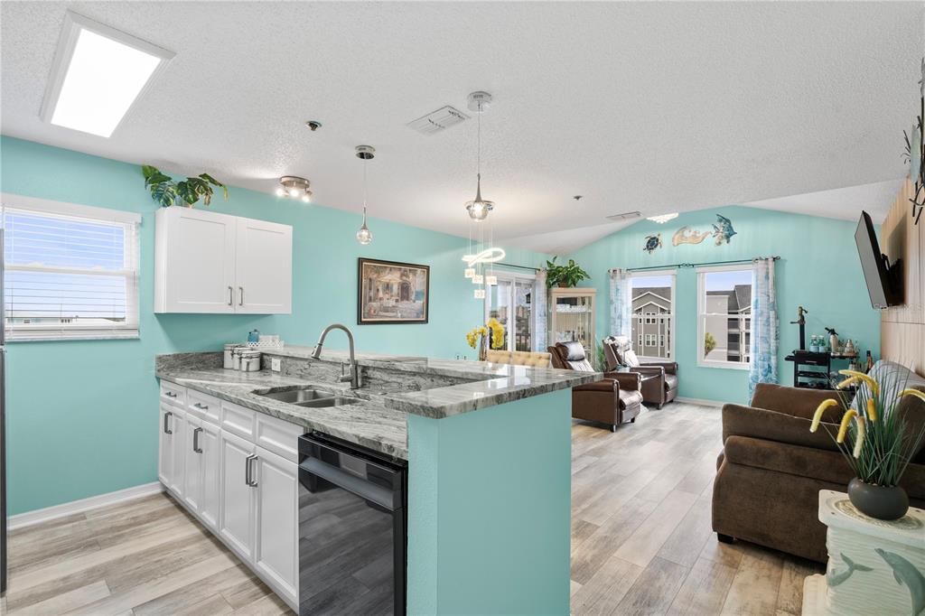 5722 Biscayne Court, Unit 308 New Port Richey, FL 34652 - Photo 8 of 31 a open kitchen with a sink stove and wooden floor
