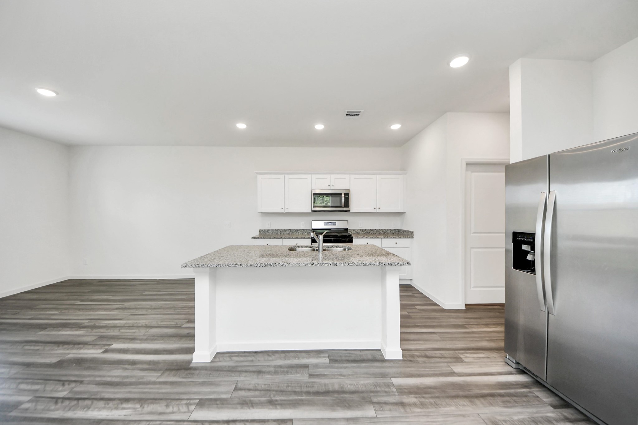 10303 Rose Mar Drive, Unit B Rosharon, TX 77583 - Photo 10 of 49 a kitchen with kitchen island a sink stainless steel appliances and cabinets