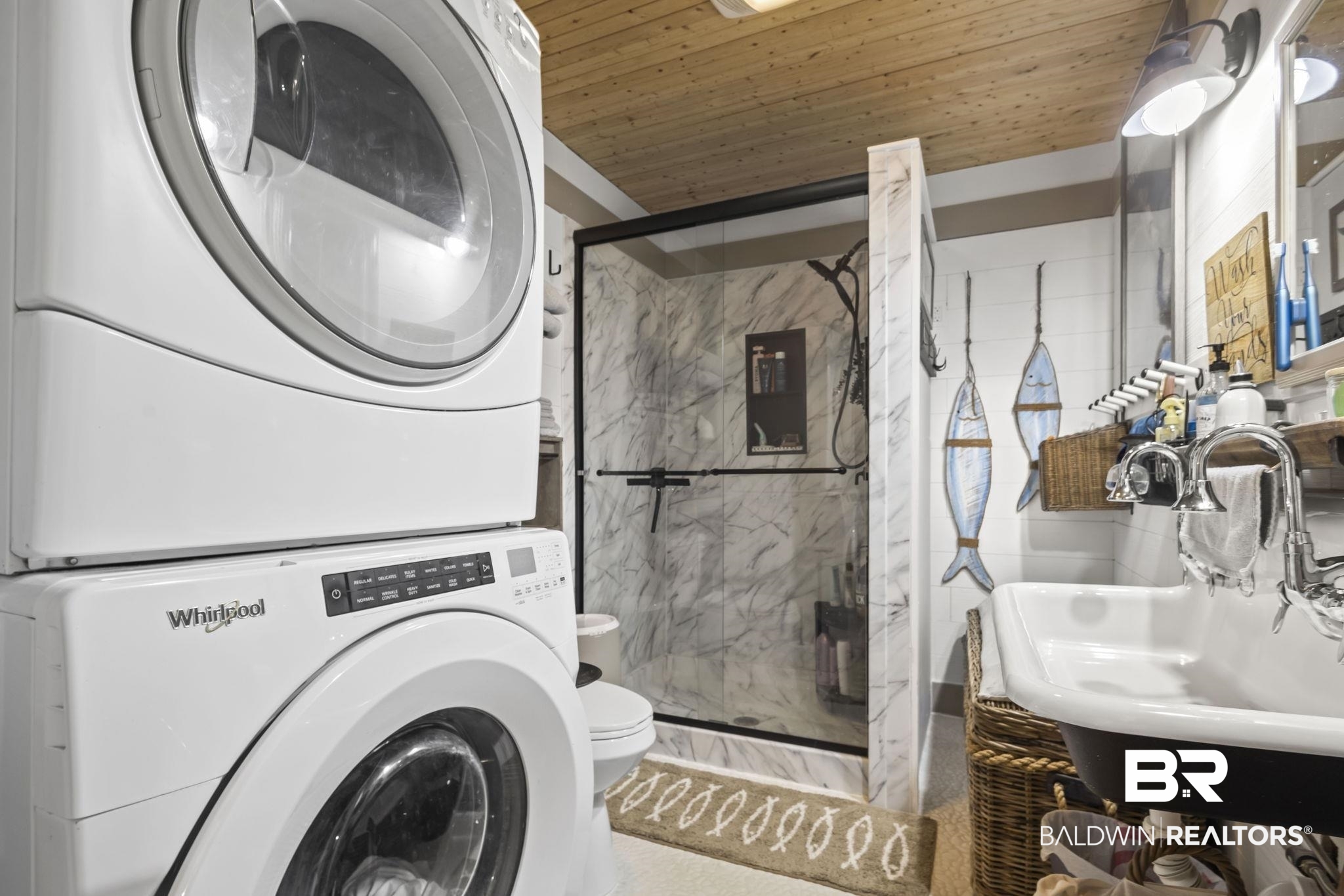 2514 Muscogee Road Gulf Shores, AL 36542 - Photo 27 of 60 Washroom featuring stacked washer / drying machine, wood ceiling, and sink