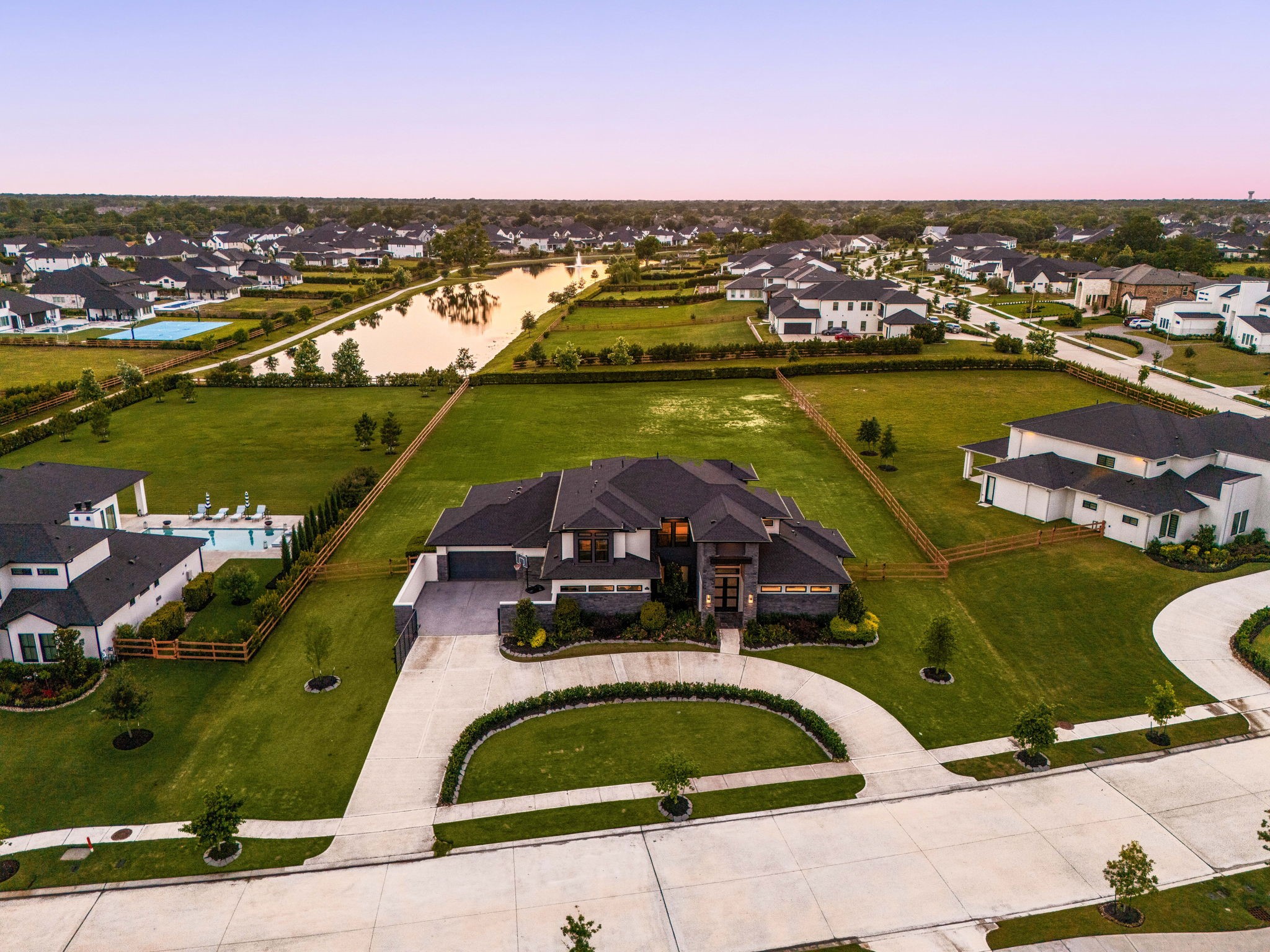 29419 Cir S Rnch Trail Fulshear, TX 77406 - Photo 2 of 45 This elevated aerial view reveals the sprawling rear elevation of the property, highlighting an expansive manicured lawn and premium lot.