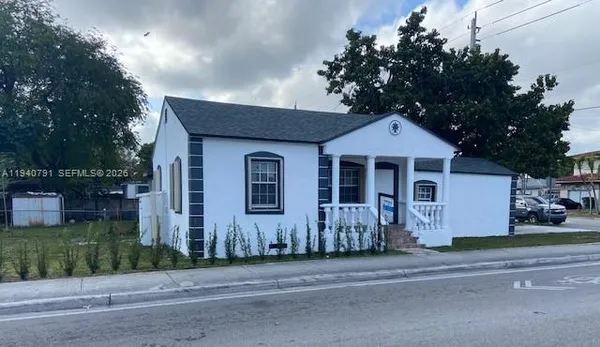 a front view of a house with a garden